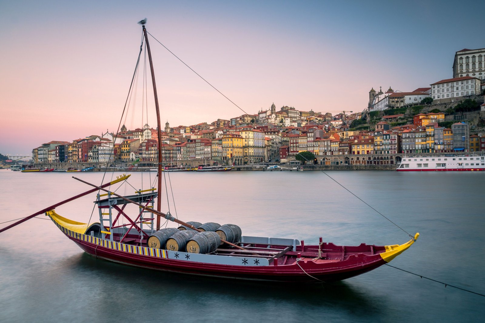 Low-angle of Porto cityscape at sunset, purple sky background